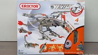 Front of the Erector Speed Play box displaying 4 motorized model options, mostly metallic metal parts with orange accents, labeled with 838 pieces and age 7+.