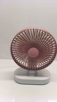 Front view of the wireless rechargeable mini fan showing rose gold fan grille and white base.