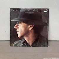 Front cover of Woody Allen Standup Comic vinyl record showing profile of Woody Allen with hat and glasses.