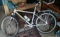Side view of silver 1996 Wheeler women's bicycle with visible water bottle, rear rack and mudguards