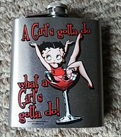 Front view of the stainless steel flask showing Betty Boop design with quote 'A Girl's gotta do what a Girl's gotta do!'