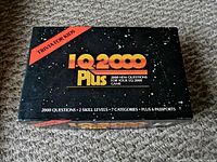 Closed box of IQ 2000 Plus trivia game for kids with visible front text.