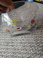 Side view of clear Hadeland glass bowl showing colorful Millefiori flowers embedded in the glass.