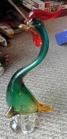 Full view of Murano glass rooster figurine sitting on the floor, showing multicolor glass and shape.