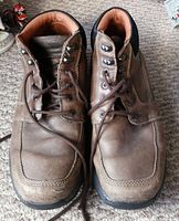 Top view of used brown leather Rockport men's waterproof boots showing the toe area with light creasing and scuffs.