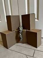 Photo showing the 5 boxes containing the elephant figurines and one figurine displayed in front.