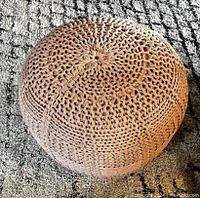 Top view showing knitted pattern and texture of pouf.