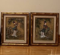 Two framed Asian-inspired paintings side by side, each depicting a woman in traditional attire, with bamboo gold-style frames.