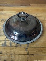 Closed view of Victorian silver plate pot with tarnished lid and ribbed edge
