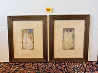 Pair of framed Art Nouveau prints shown side by side on a carpeted floor against a white wall.
