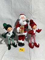 Full view of three vintage Christmas figures: Santa and two Annalee elves, showing full body and details of their outfits and poses.
