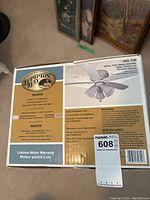 Box label showing Hampton Bay Maris indoor ceiling fan, 44 inch blade span, lifetime motor warranty, and features for quiet, wobble-free operation.