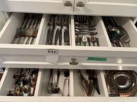 Two drawers with Community flatware and assorted serving pieces
