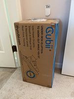 Closed cardboard box labeled MyCubii Under Desk Elliptical with product features and branding.