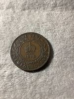 Reverse side of the 1913 Newfoundland one cent coin showing the crown, year, wreath, and inscriptions.