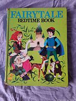 Cover of 'Fairytale Bedtime Book' showing illustrated children and animals on a green background with wear on spine and edges