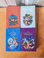 Front covers of four Jenny Nimmo books: The Shadow of Charlie Tong, The Time Twister, The Blue Boa, and The Castle of Mirrors