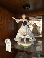 Wallendorf porcelain figurine displayed on a glass shelf, showing full figure and base.