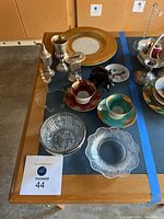 Overall view of the set including silver plates, crystal dishes, teacups and decorative items
