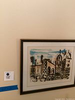 Painting of the old city of Jerusalem, framed and hung on a wall with blue painter's tape beneath showing measurements 22x26