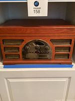 Front view of the Crosley wooden stereo record player showing the speaker grills and control panel.