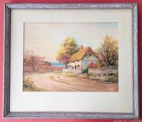 Full view of the framed watercolour painting showing a countryside cottage, trees, a road, and ducks, under glass in a wooden frame.