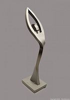 Front angled view of forged steel abstract female figure sculpture with raised arms.