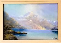 Framed and matted pastel painting showing mountain peak with lake and trees, signed bottom right.