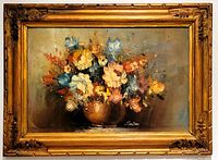 Front view of vibrant floral still life oil painting in ornate gold wood frame, signed lower right 'Sanders'