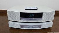 Front view of Bose Wave Music System top unit and 4-disc CD changer module stacked