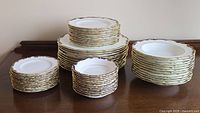 Stacks of plates and bowls on wooden surface