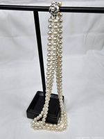 Full view of double strand necklace draped on stand
