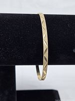 Side view on black velvet showing etched pattern