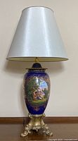 Full view of lamp showing porcelain body, metal base, and shade