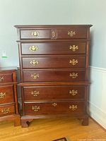 Full front view of two-piece highboy dresser