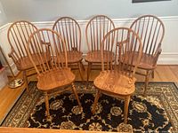 Six oak dining chairs—two armchairs in back row and four side chairs in front
