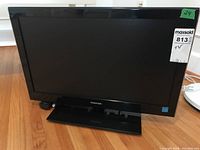 Full front view of Toshiba 24" LED TV with black frame and base, model appears to be 24SLV411U as per seller description. The TV is turned off.