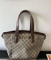 Full front view of the Gussaci tote purse showing shape, handles, and front hardware detail.