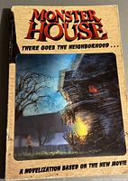 Front cover of Monster House novelization book showing the title, artwork of haunted house, and text indicating it's based on the movie.