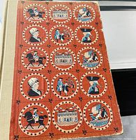 Front cover of The Golden Book of America showing illustrated historical American scenes and figures in circular frames on an orange background.
