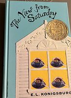 Front cover of The View from Saturday hardcover book showing title, illustration, author, and award medallion.