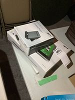 Lot shown on white table surface including Acer Iconia Tab box beneath smaller Acer Docking Station box.