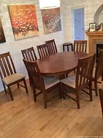 Full view of round table with eight chairs arranged around