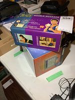 Box of Dr Hos Double Massage handheld massager on table showing front and side panels with branding and product images