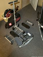 Leg Magic and Rock n Roll steppers visible on carpet floor with tennis rackets in background.