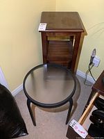 Overall view showing both the small round metal and wooden side tables in corner.