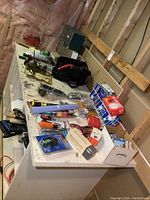 Overview of assorted tools and hardware on workbench