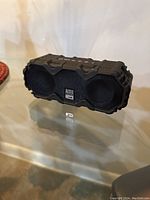 Front view of Altec Lansing Bluetooth speaker showing black metal grille and logo.