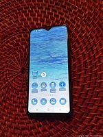 Front view of Samsung Galaxy A10e powered on with visible home screen and app icons.