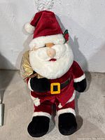 Front view of Santa Claus plush toy showing full outfit including beard and sack
